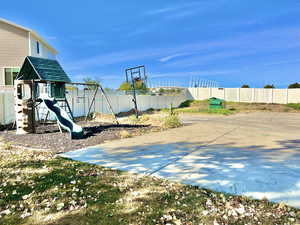 View of basketball court featuring a playground