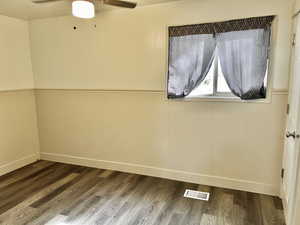 Spare room featuring hardwood / wood-style floors and ceiling fan