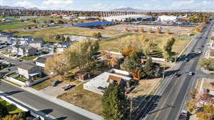 Birds eye view of property featuring Olympic Oval Venue, Kearns Park & Recreations Center, Kearns High School, and a mountain view