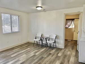 Sitting room with hardwood / wood-style floors