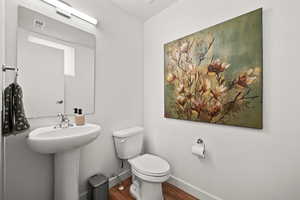 Bathroom featuring hardwood / wood-style flooring and toilet