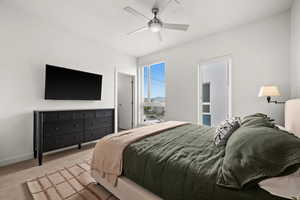 Carpeted bedroom featuring ceiling fan