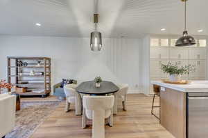 Dining space with light hardwood / wood-style floors