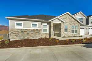 Craftsman house featuring a mountain view, central AC unit, and a garage