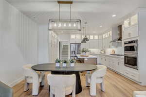 Dining area with light hardwood / wood-style floors and a chandelier