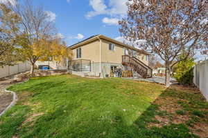 Rear view of property featuring a lawn