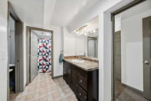 Bathroom featuring vanity and a textured ceiling