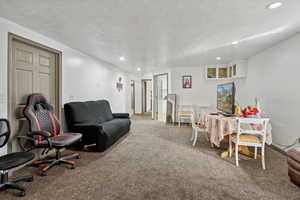 Living room with carpet floors and a textured ceiling