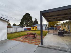 View of patio featuring a storage shed