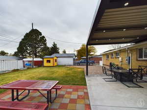 View of patio featuring a shed