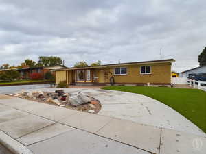 Ranch-style house with a front lawn