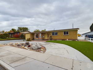 Ranch-style house with a front lawn