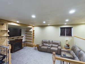 Carpeted living room featuring a textured ceiling