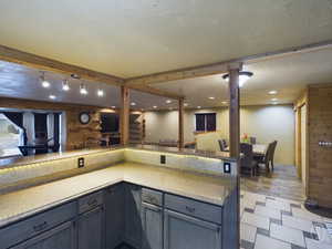 Kitchen featuring wood walls, light wood-type flooring, and a textured ceiling