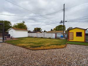 View of yard with a storage unit and a patio area