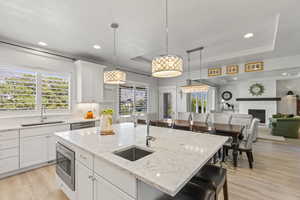 Kitchen featuring a center island with sink, plenty of natural light, stainless steel appliances, and sink