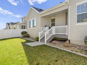 View of exterior entry featuring a yard