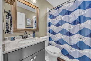 Bathroom featuring vanity, toilet, and walk in shower