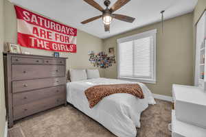 Carpeted bedroom with ceiling fan