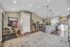 Kitchen featuring dishwasher, vaulted ceiling, decorative light fixtures, and a kitchen island