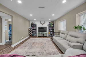 Living room with wood-type flooring