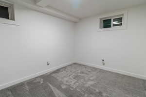 Basement bedroom featuring carpet flooring