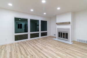 Unfurnished living room featuring light hardwood / wood-style floors