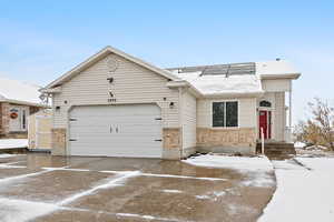 Ranch-style house with a garage and a storage shed