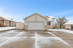 View of front of house with a shed and a garage