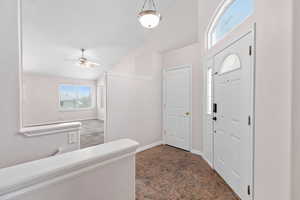 Entryway with lofted ceiling and ceiling fan