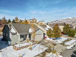 View of front of house with a mountain view and a garage