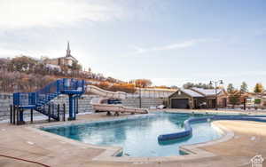 View of pool with a water slide