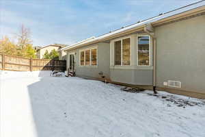 View of snow covered rear of property