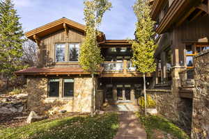 Back of house with a balcony and french doors