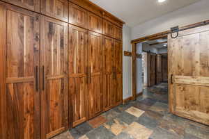 Corridor featuring a barn door