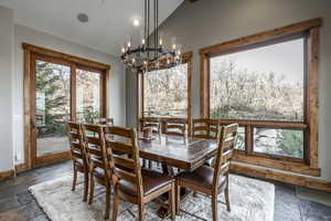 Dining space featuring lofted ceiling and a notable chandelier