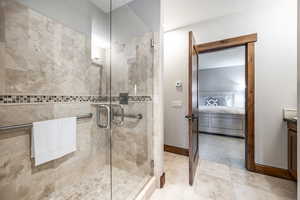 Bathroom with tile patterned flooring, vanity, and an enclosed shower