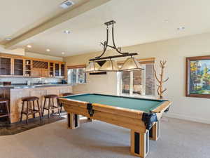 Playroom featuring bar, dark carpet, and pool table