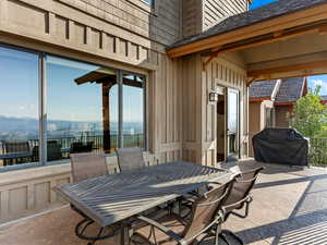 View of patio with a grill