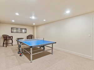 Game room with light colored carpet