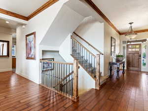 Entryway featuring dark hardwood / wood-style flooring and ornamental molding