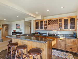 Kitchen with a breakfast bar area, sink, and a center island