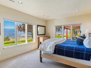 Bedroom featuring access to exterior, a mountain view, and carpet