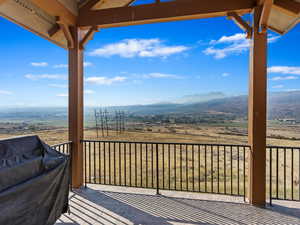 Wooden terrace featuring a mountain view and a rural view