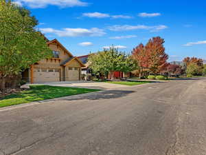 View of front of property featuring a front yard and a garage