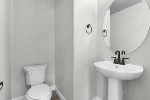 Bathroom featuring toilet and hardwood / wood-style floors