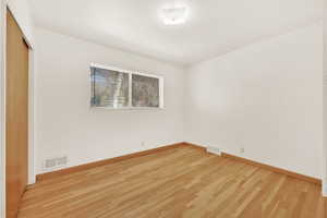 Empty room featuring hardwood / wood-style floors