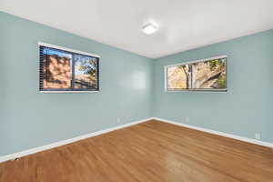 Empty room with hardwood / wood-style flooring