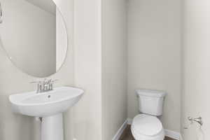 Bathroom with wood-type flooring and toilet