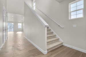 Staircase featuring hardwood / wood-style floors